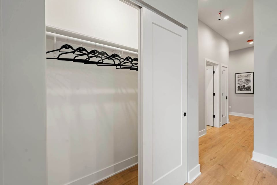 Clean closet space that keeps clothing organized and the room feeling open.