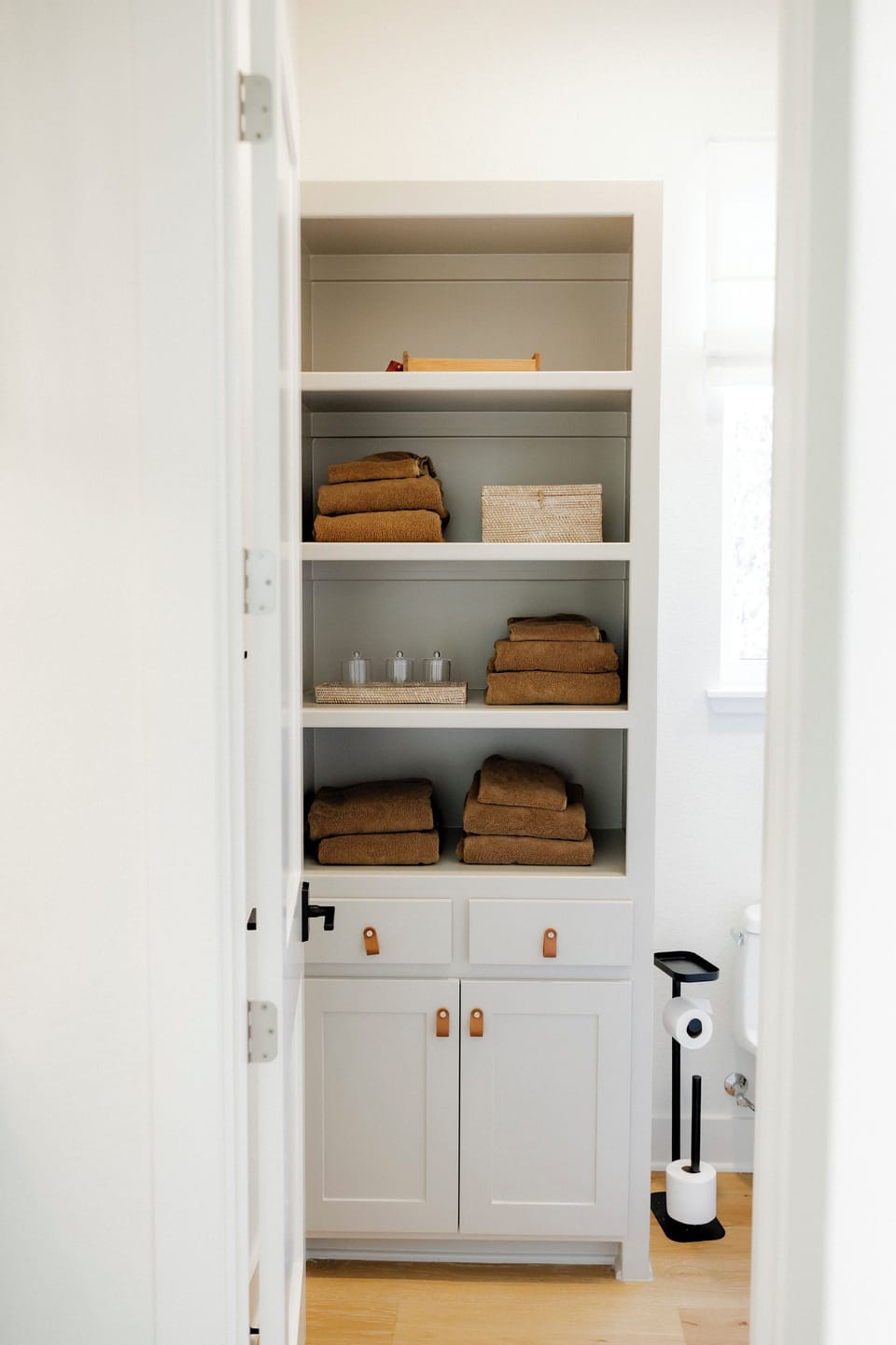 Spa-ready linen closet with plush towels and essentials provided.
