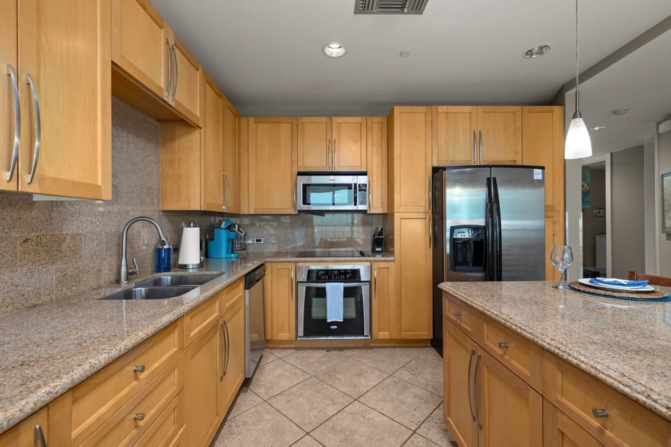 Fully equipped kitchen with stainless steel appliances and bar seating