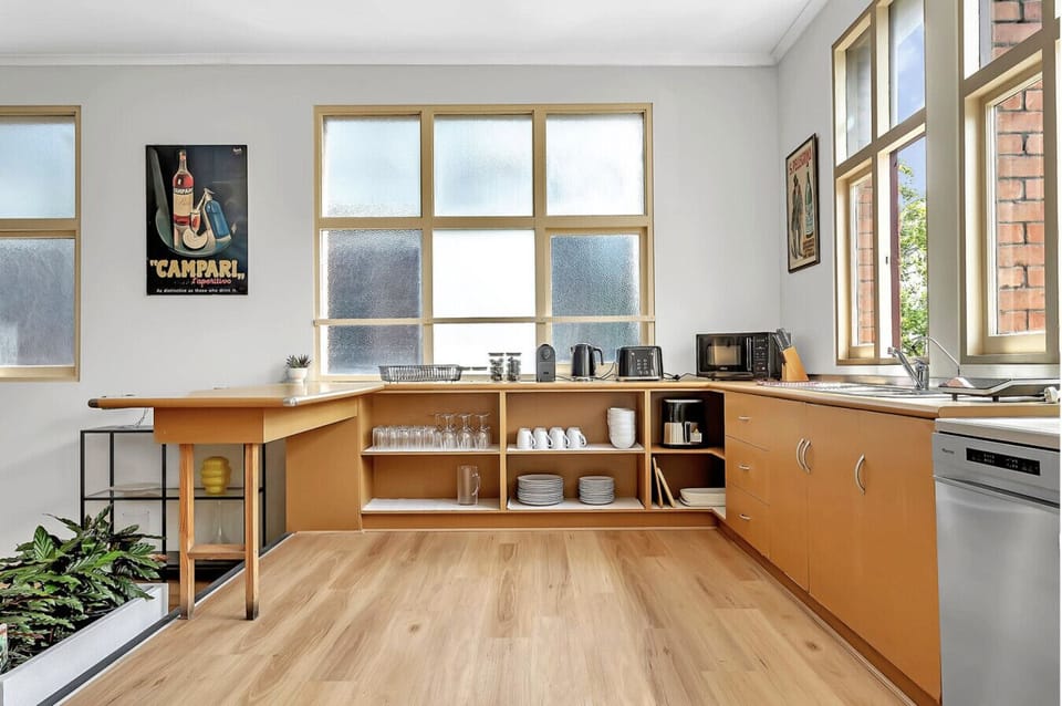 Fully equipped kitchen with modern appliances and open shelving for a true `home away from home` feel.