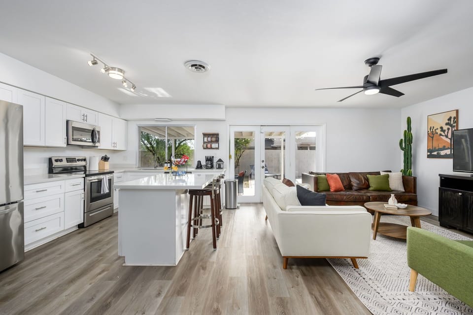 A bright, open-concept space where the kitchen and living room flow together, perfect for cooking, relaxing, and spending time as a group.