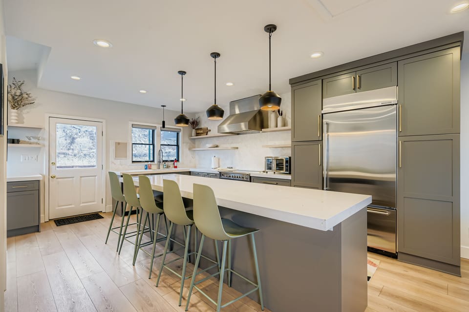 Step into your gourmet kitchen where culinary dreams come alive! This stunning space features gleaming stainless steel appliances, elegant pendant lighting, and a spacious island.