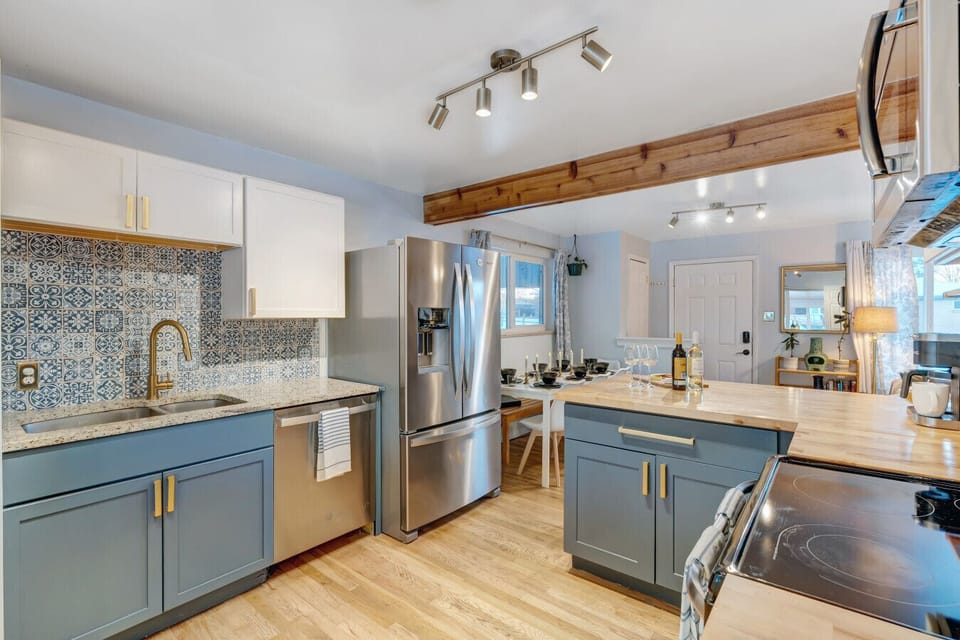 This beautifully remodeled kitchen has stainless steel appliances, butcher block counters, and open flow.