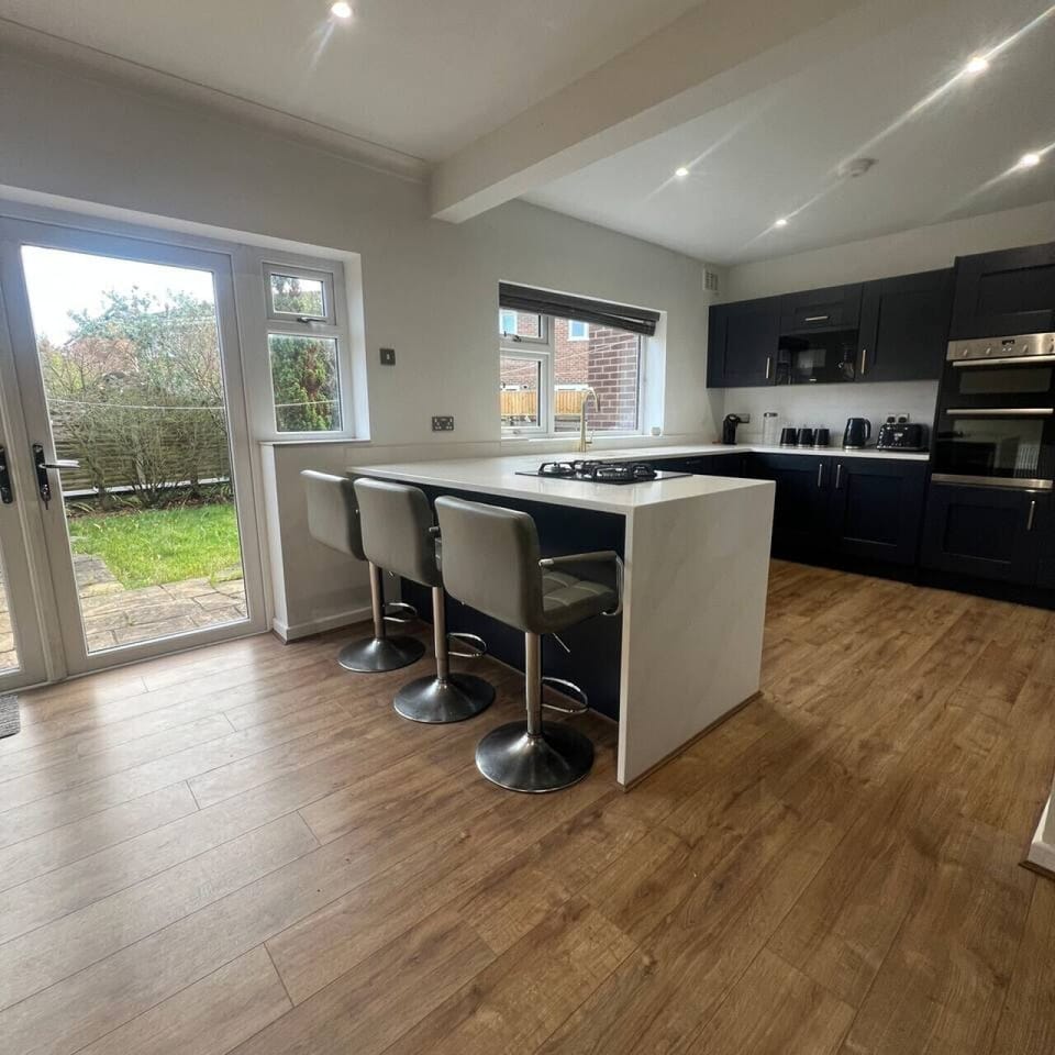 Kitchen and bar stools overlooking private garden