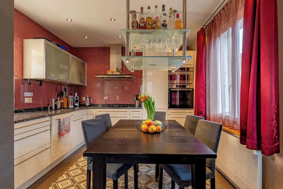 Open kitchen with dining area and warm lighting
