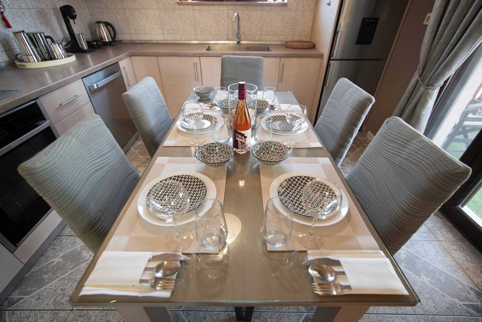 Elegant dining table beautifully set for meals, offering a warm and inviting space to enjoy breakfast or dinner with family and friends.
