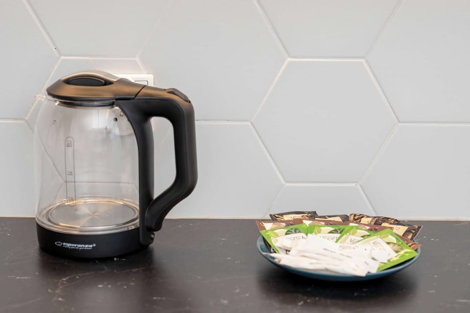 The kettle on the countertop lets you prepare your morning tea or evening brew with ease, adding convenience to your stay.