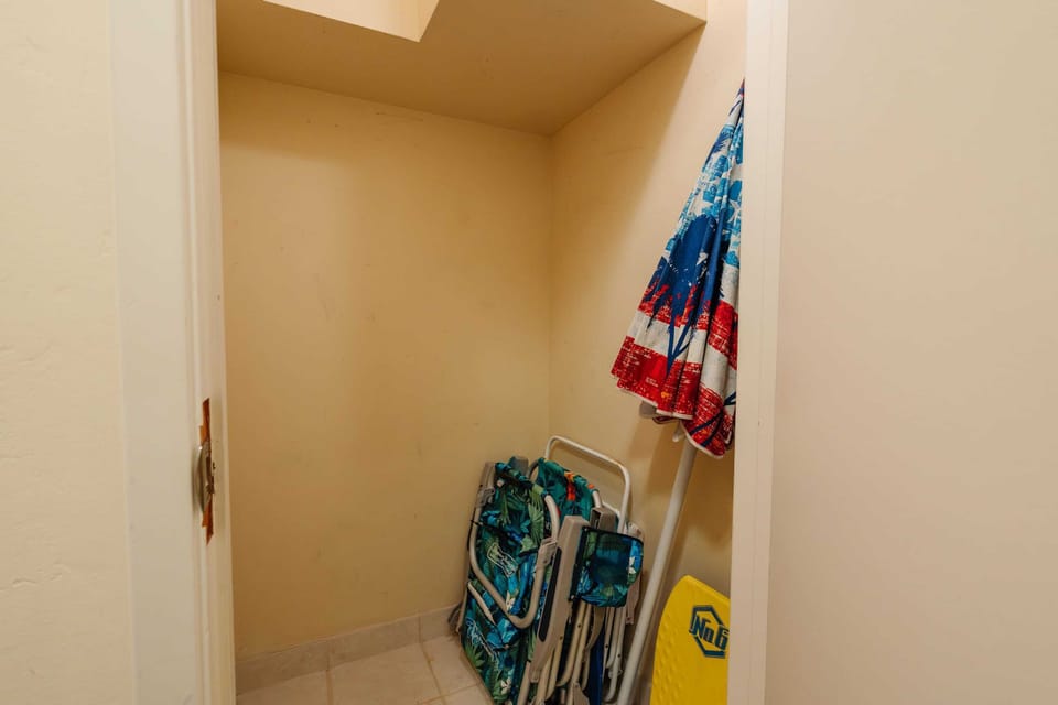 The handy storage closet is stocked with provided beach chairs, ready for your seaside adventures.