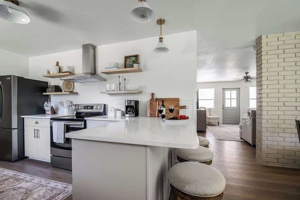 The kitchen features a spacious countertop with bar seating, creating a casual spot for dining, morning coffee, or conversation while cooking.