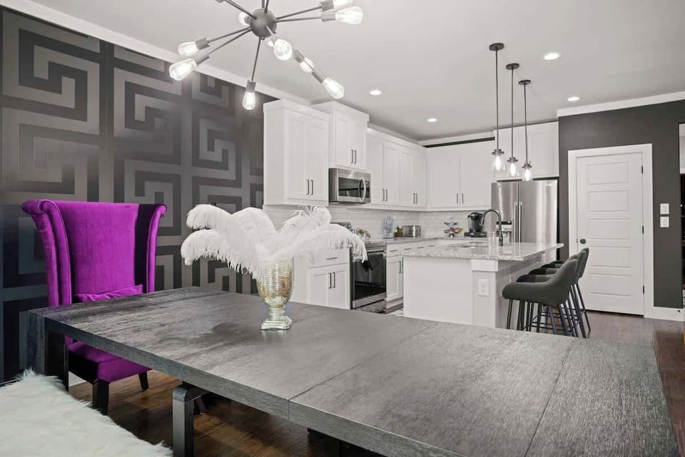 Throne Room 

Modern extendable dining table with purple velvet high-back throne chairs, capable of hosting 16 patrons. 