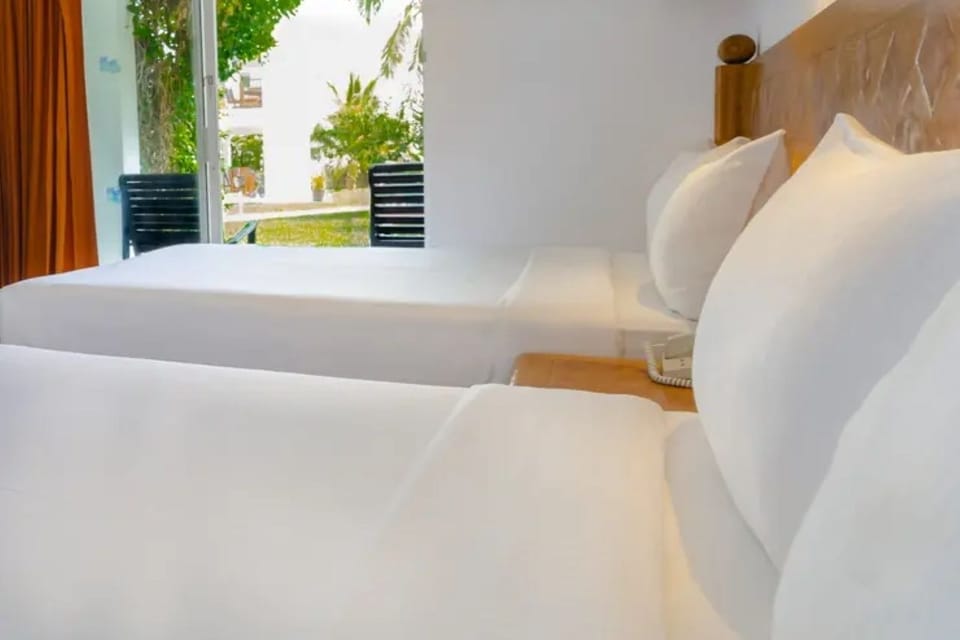 Drift off on smooth sheets with soft light and greenery.