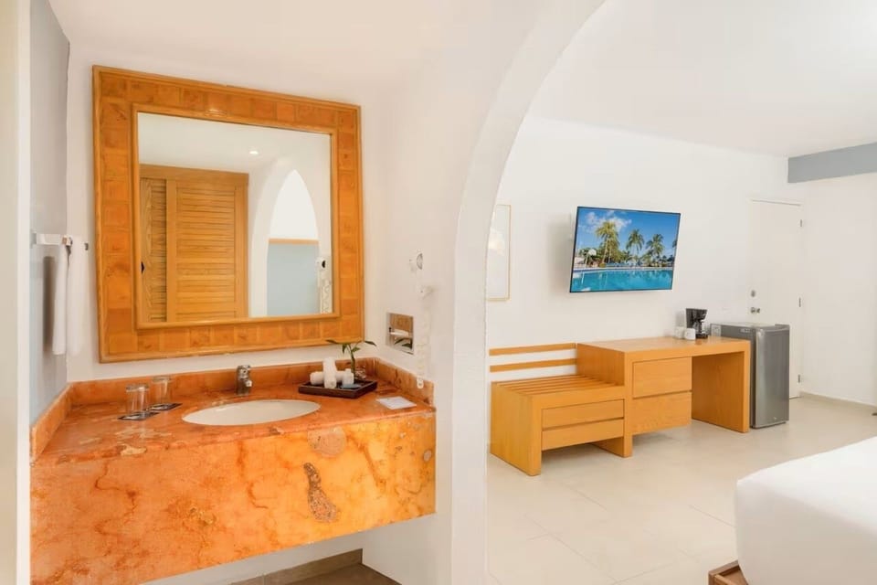 Refresh at the elegant vanity with warm stone finishes.