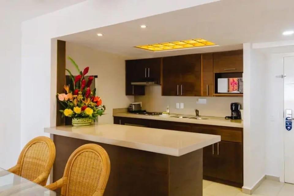 Cook comfortably with sleek counters and warm wood cabinetry.