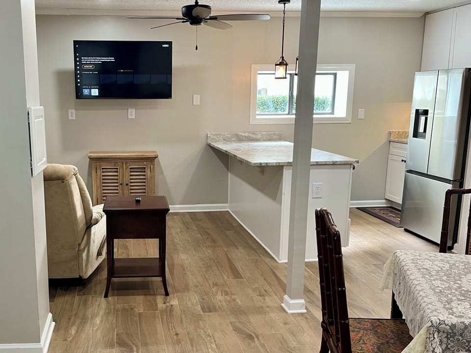 Downstairs game area with kitchenette, card table, recliner and Smart TV