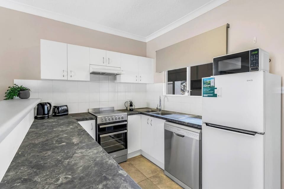 The kitchen is thoughtfully equipped with an oven, stove, dishwasher, fridge and microwave, making everyday cooking feel effortless during your stay.