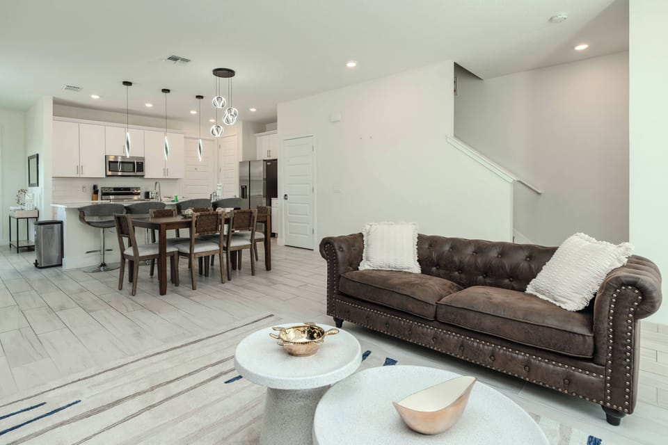 Spacious open-concept living area connecting the lounge, dining space, and kitchen, with comfortable seating, modern décor, and plenty of room for families to relax, dine, and enjoy time together.