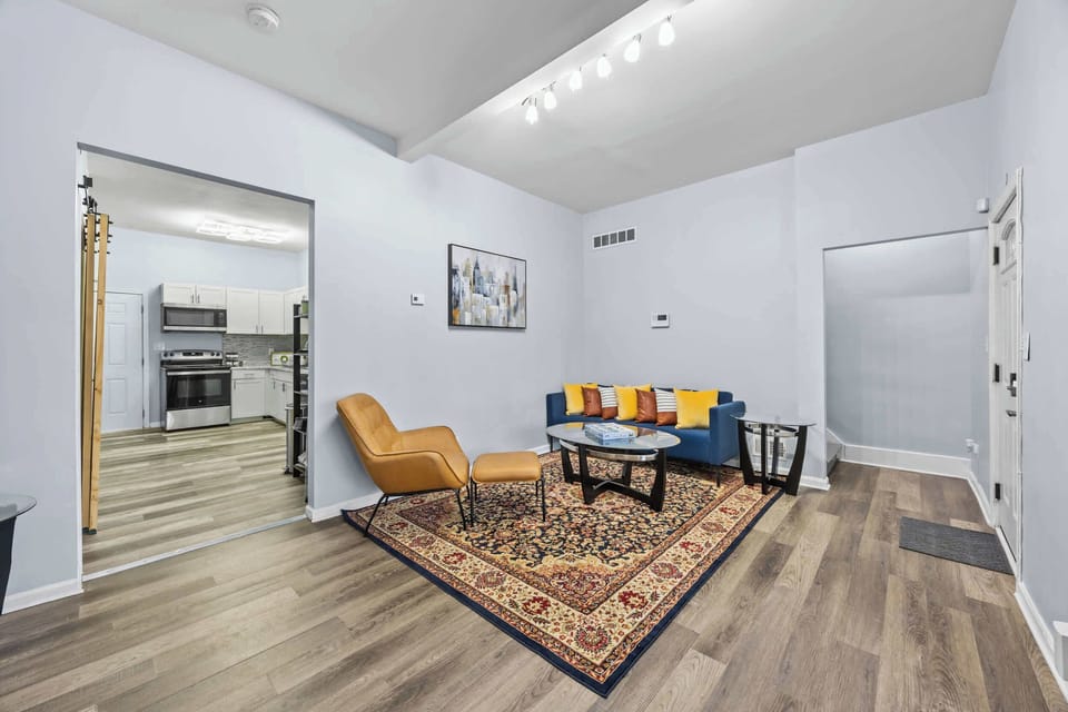 Living Area: This living room features sturdy, practical furniture built for extended use, ensuring longevity and comfort for families or traveling colleagues. Our home's clean, open layout offers maximum functional flexibility.