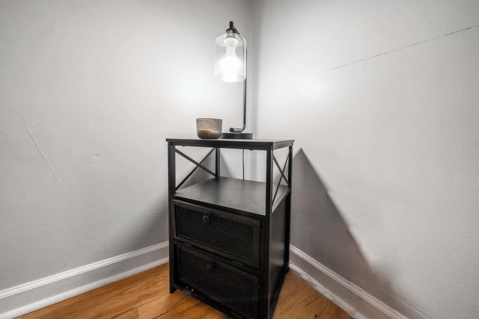 Bedroom 1: A convenient lamp placed right beside the reading nook.