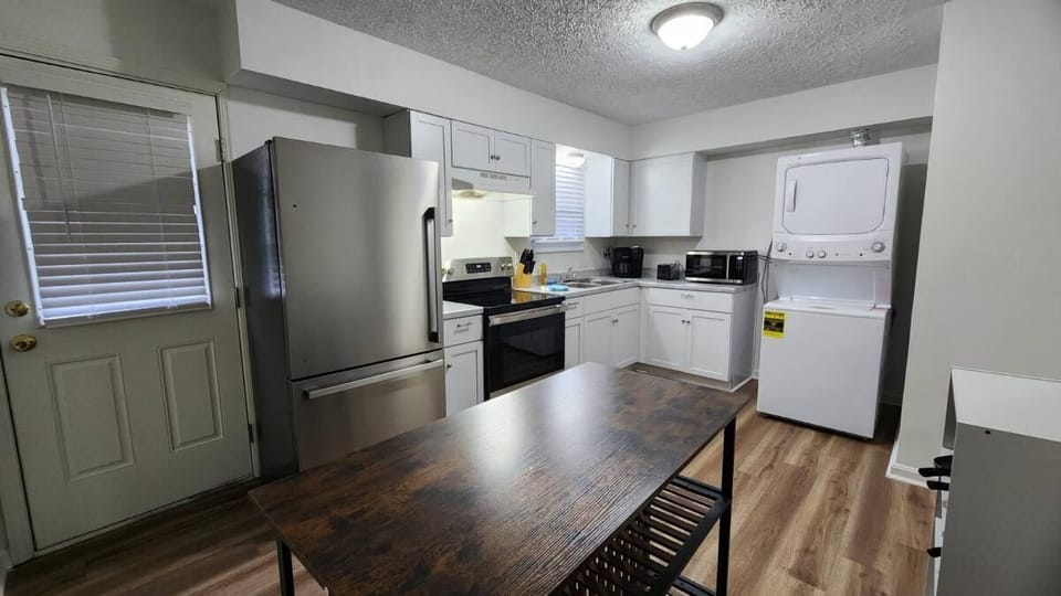 Kitchen: A simple dining set for 4 is perfectly positioned for meals and gatherings.