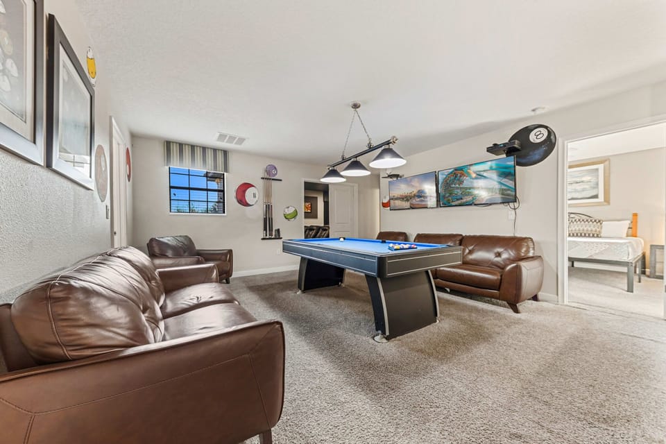 A fun, open loft featuring a pool table and games, perfect for friendly competition and family fun.