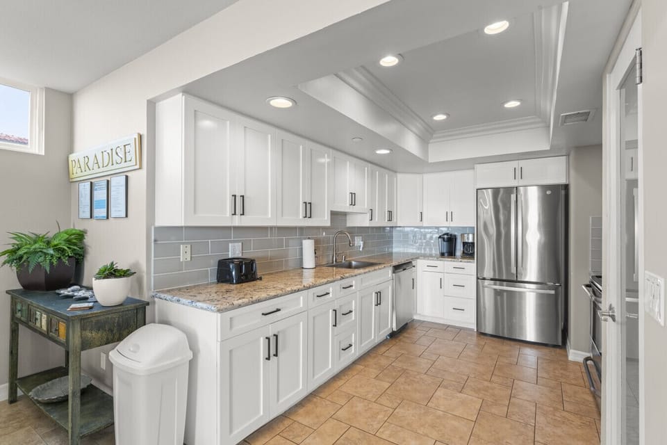 Spacious galley-style  and fully-equipped kitchen offering ample counter space, modern finishes, and easy access to all appliances.