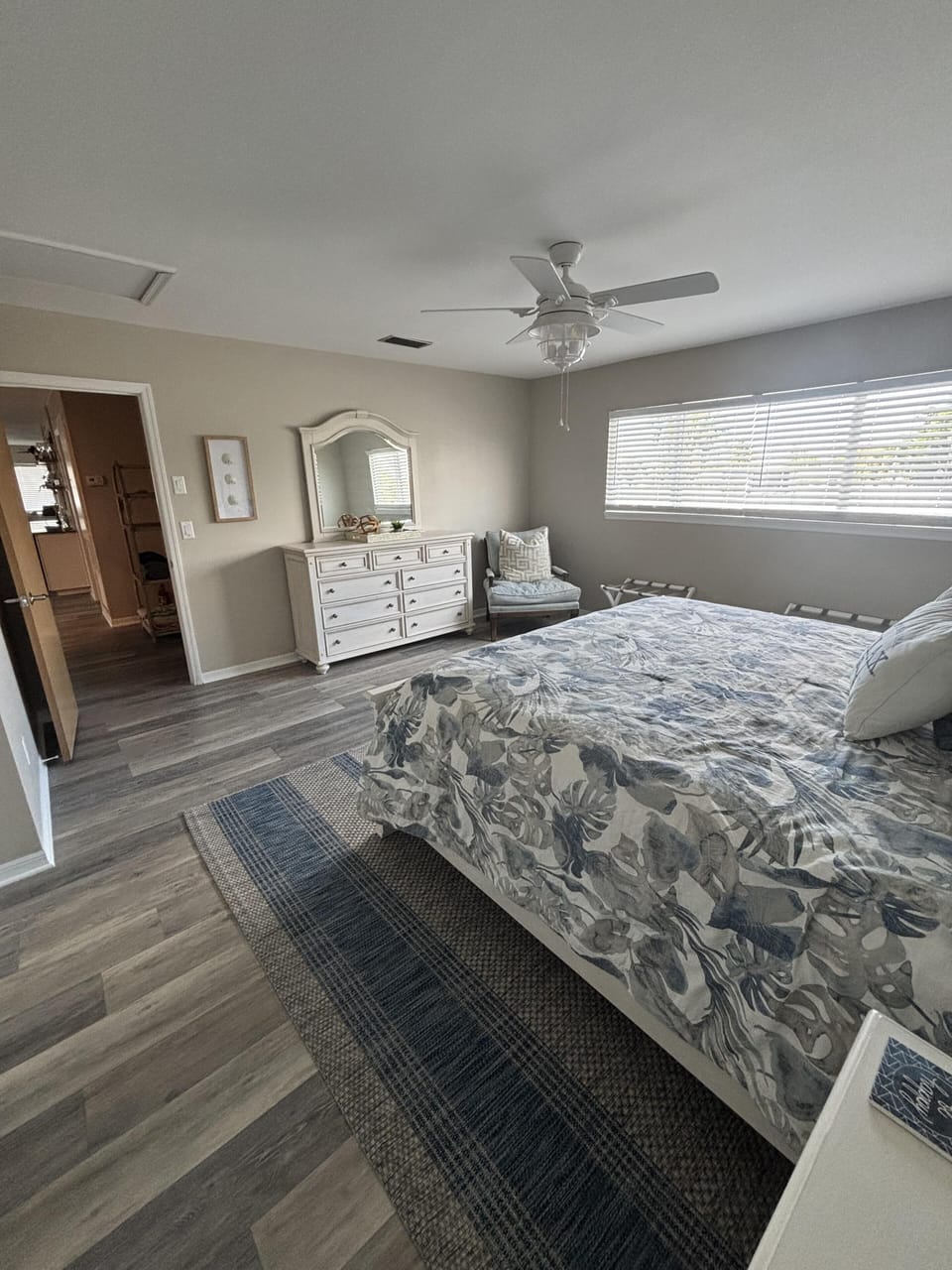 Spacious bedroom with cozy bedding and natural light