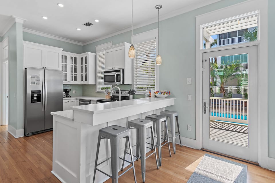 Fully Stocked Kitchen - Cook in style in the remodeled kitchen with plenty of supplies and appliances, all with Pool and backyard views! 
