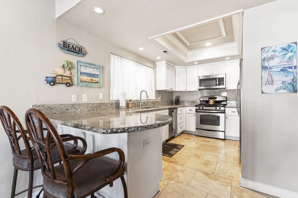 Spacious kitchen with bar seating and full cooking amenities.