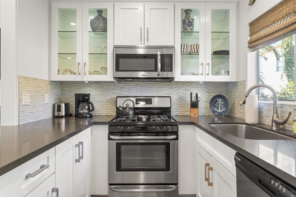 Modern kitchen w/ sleek counters, stainless appliances & plenty of space for cooking