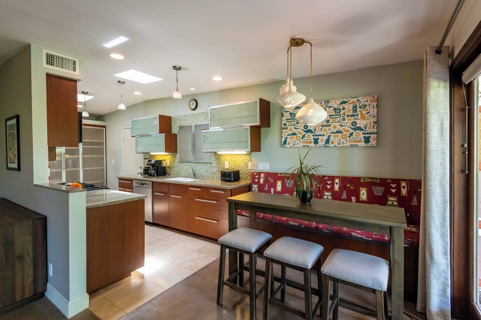 Modern kitchen with breakfast nook, bar seating & skylights