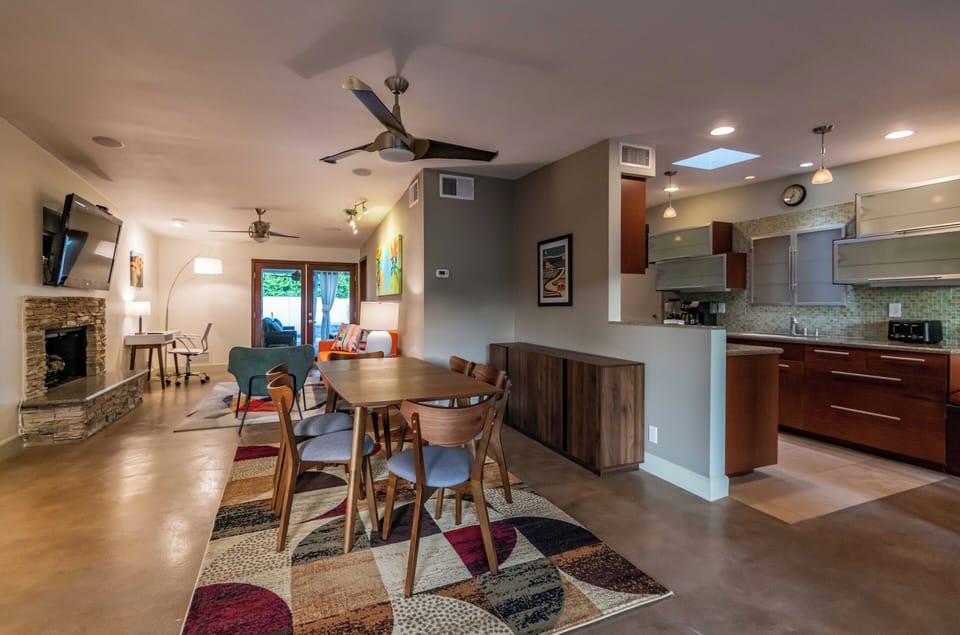 Open-concept living, dining & kitchen with modern desert design