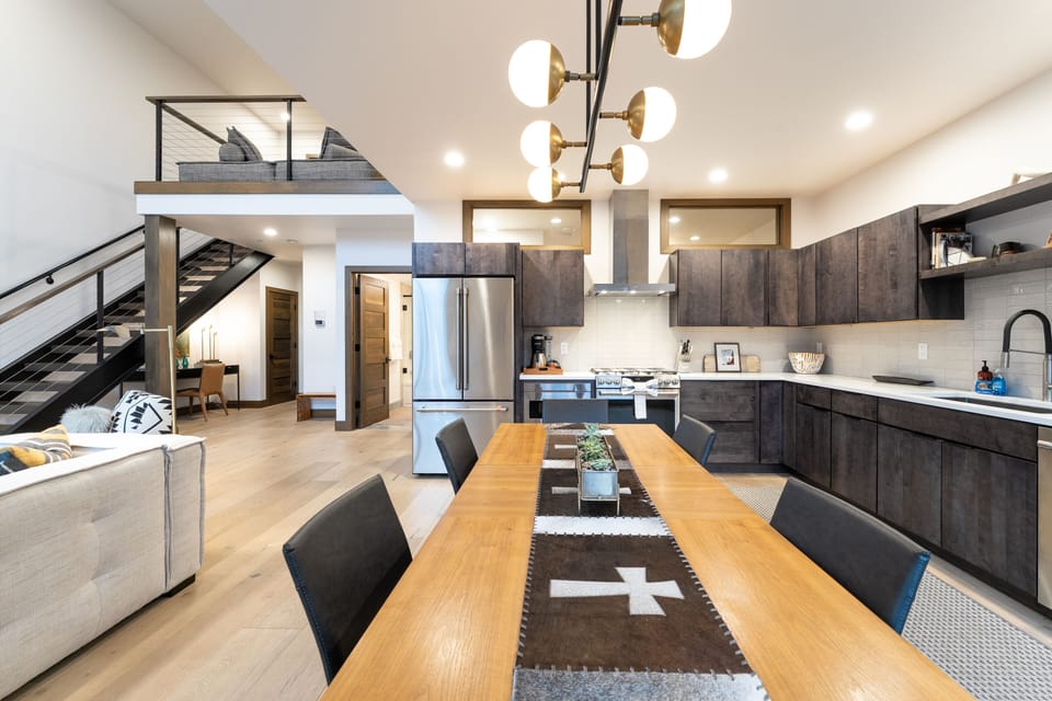 View of the kitchen and open living area from dining room table | Interior