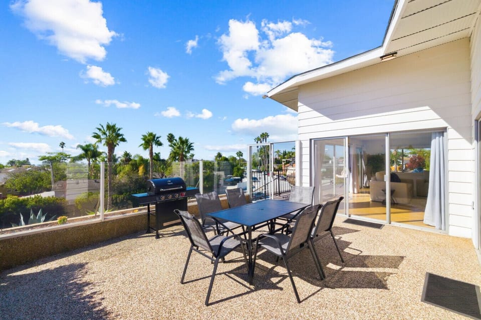 Step outside to a spacious patio with a BBQ grill and outdoor dining set. The perfect spot to relax and eat outside.