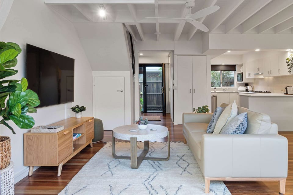 Cosy living room with a smart TV and sofa.