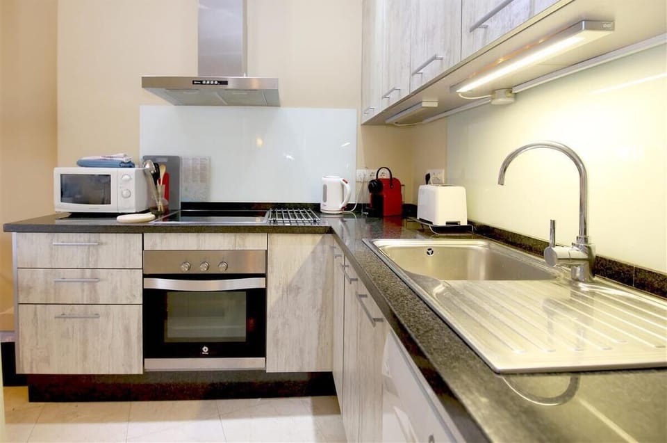 Modern open kitchen is fully fitted with all the appliances