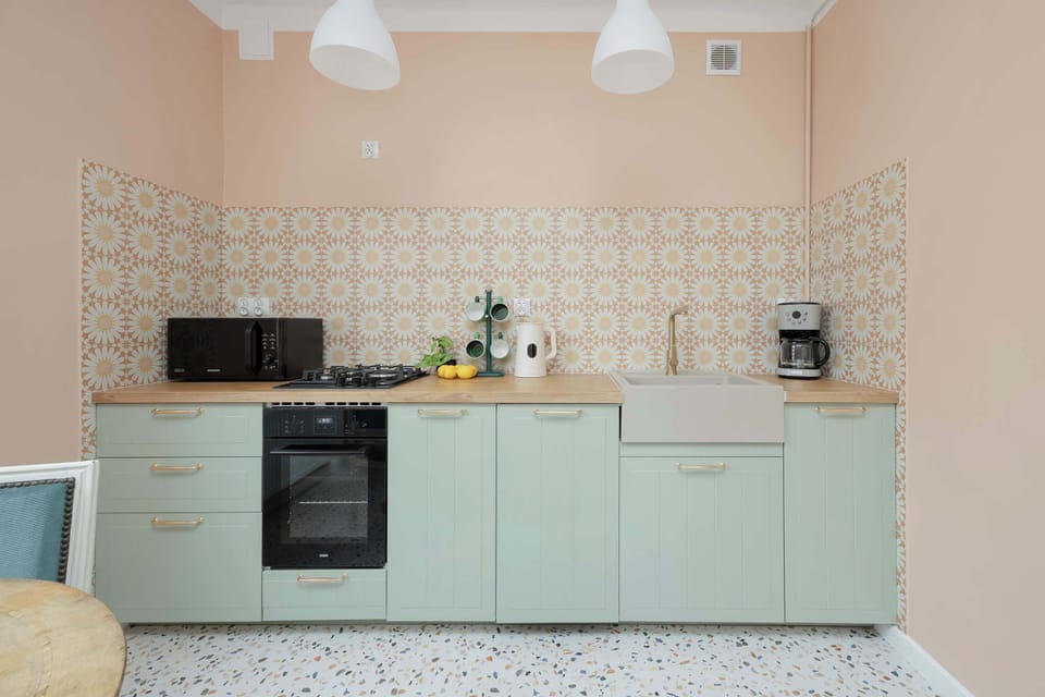 Bright kitchen featuring patterned backsplash and practical cooking essentials.