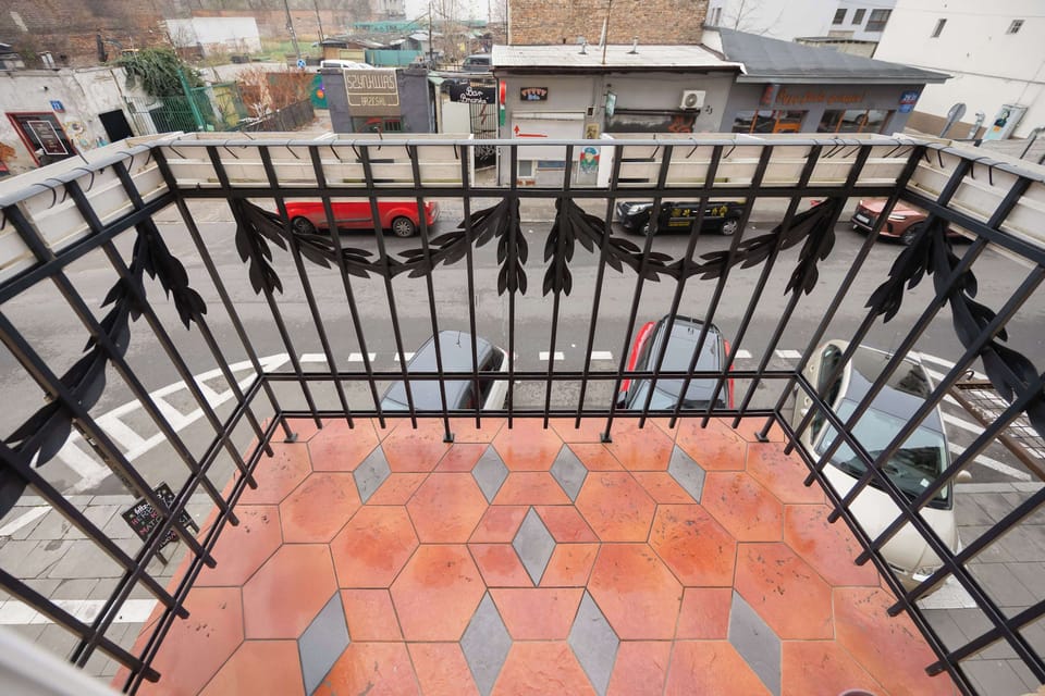 Private balcony with classic tiles and courtyard view.