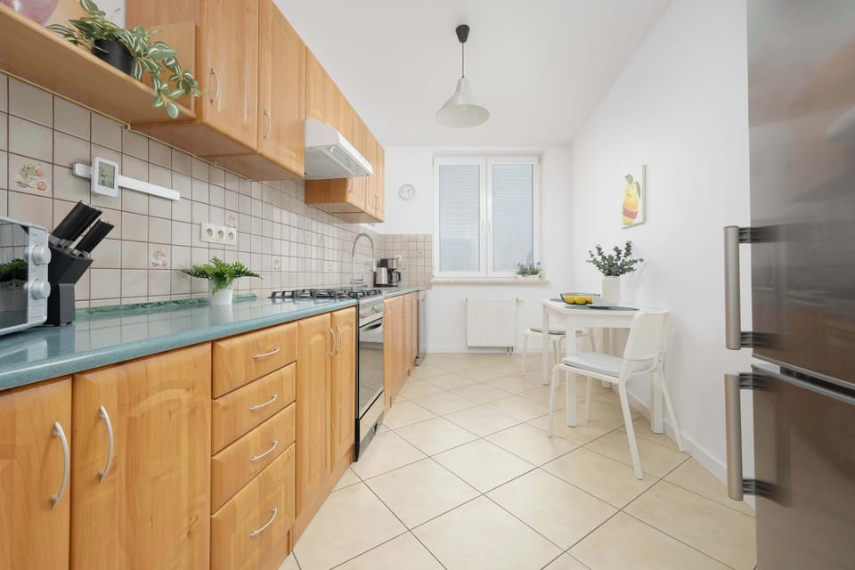 Spacious kitchen featuring wooden cabinetry and all necessary appliances.