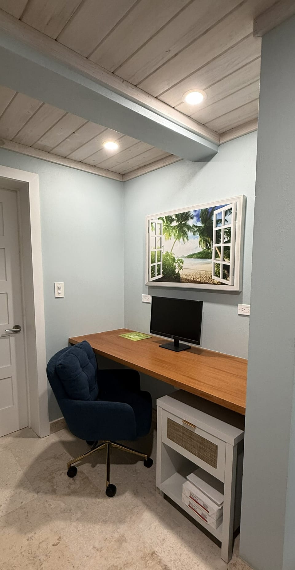 Work space with monitor, plenty of lighting and plugs.