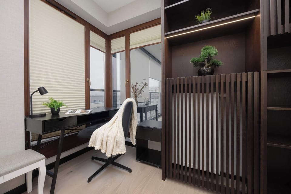 Quiet home office with glass walls and natural daylight.