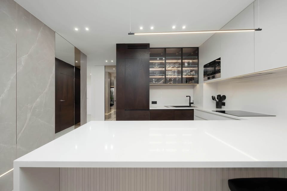 Bright kitchenette with white cabinetry and modern appliances.