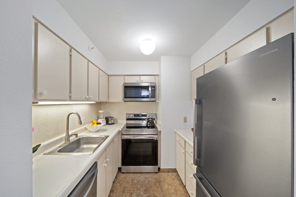 Modern kitchen with white cabinetry, stainless appliances, and clean, minimal design.