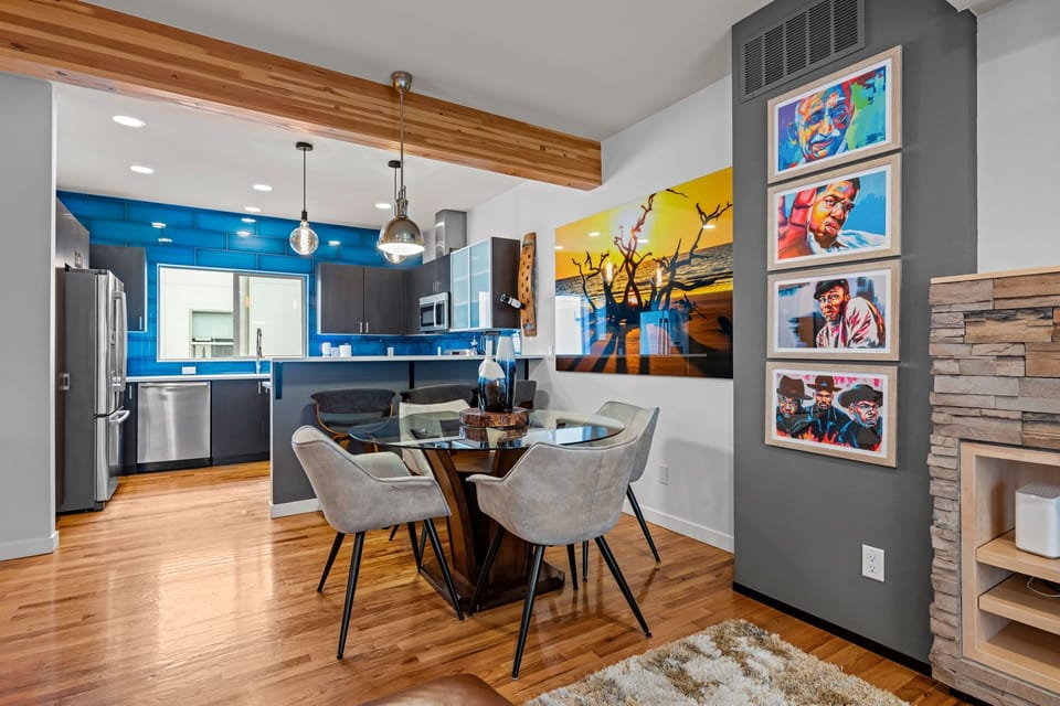 Sleek modern kitchen with stainless appliances and granite counters—fully stocked for extended staysOpen living and dining area flows seamlessly into kitchen—perfect for working professionals