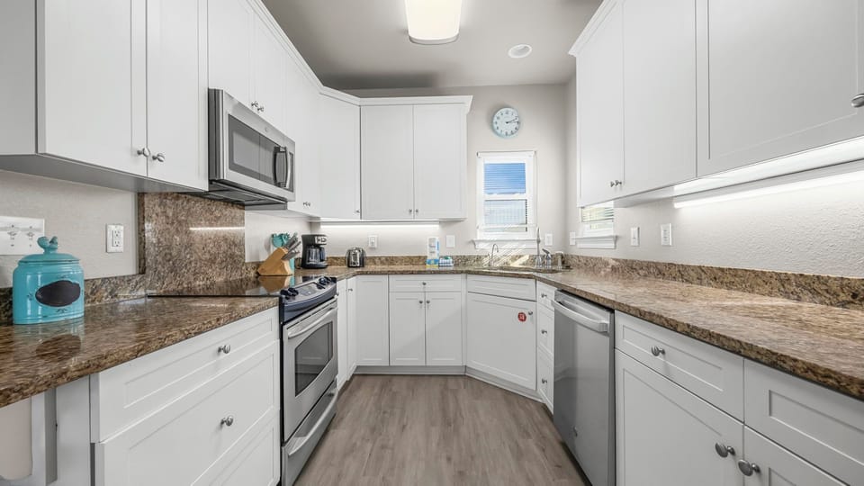 Dune Our Thing - Kitchen with all essential appliances and tools for convenient meal preparation.