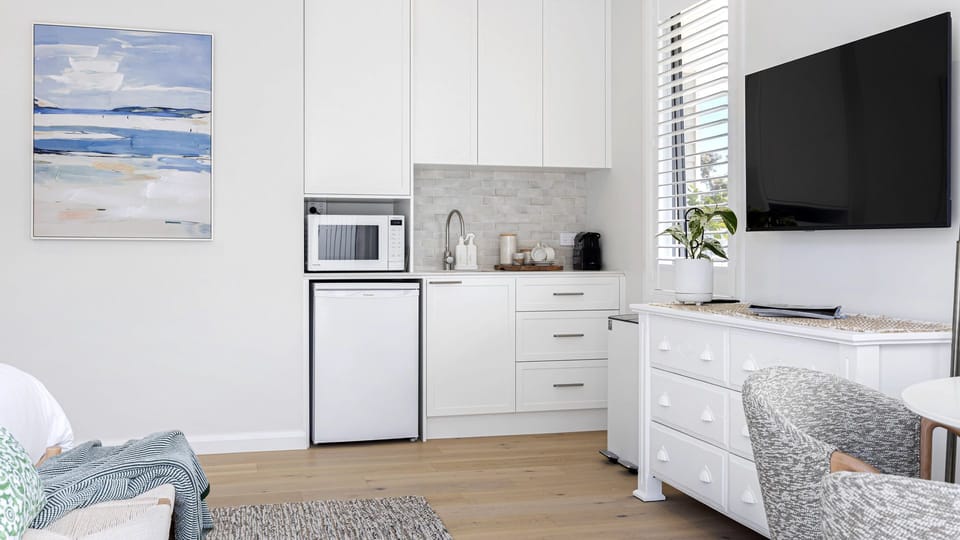 Kitchenette with microwave, mini fridge, toaster and Nespresso coffee machine