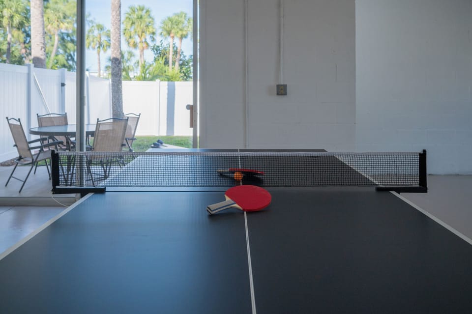 Game room on ground floor with ping pong and foosball
