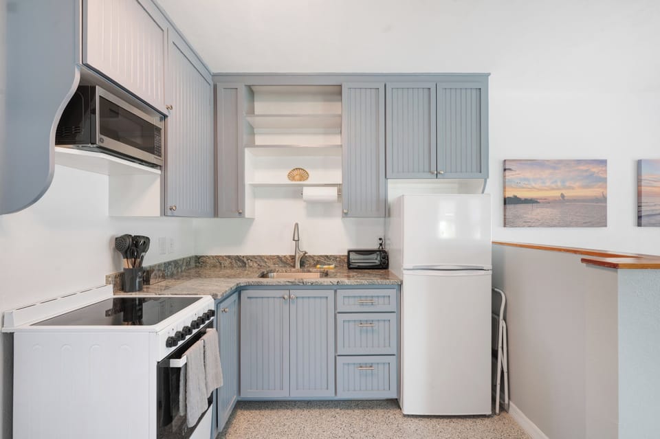 Updated kitchen with apt size electric range and refrigerator