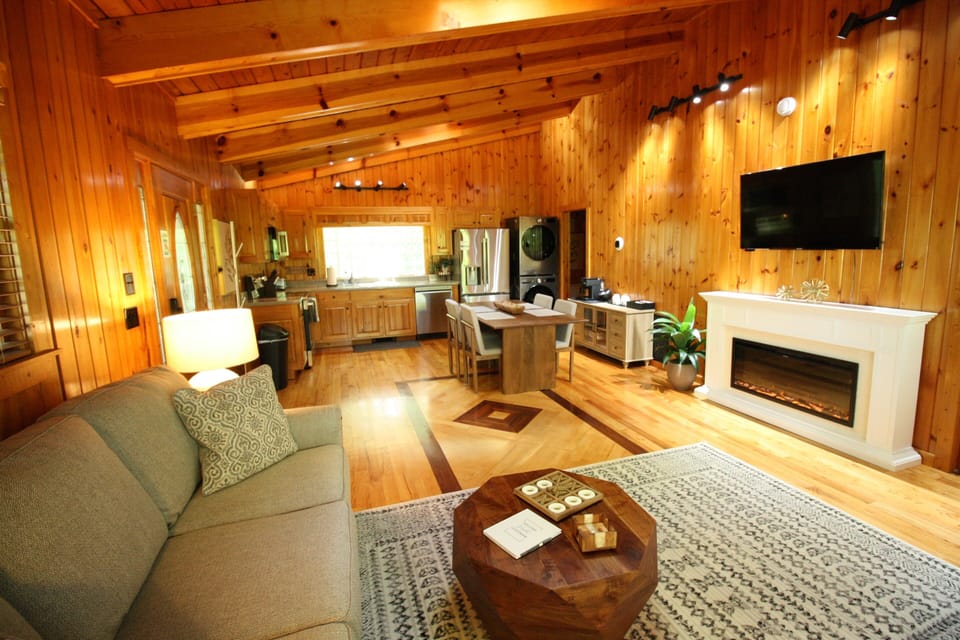 UPPER SUITE: Relax N Unwind by the fireplace with a mounted TV, gather around the dining table for meals, or enjoy the convenience of the modern kitchen—all in one comfortable, thoughtfully designed area.  