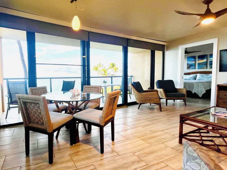 Dining area with 48" round glass table and 4 matching chairs.