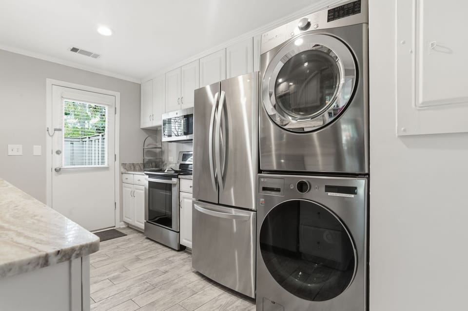 Your fully-equipped kitchen flows seamlessly into a convenient laundry area, making meal prep and fresh linens effortless during your stay.